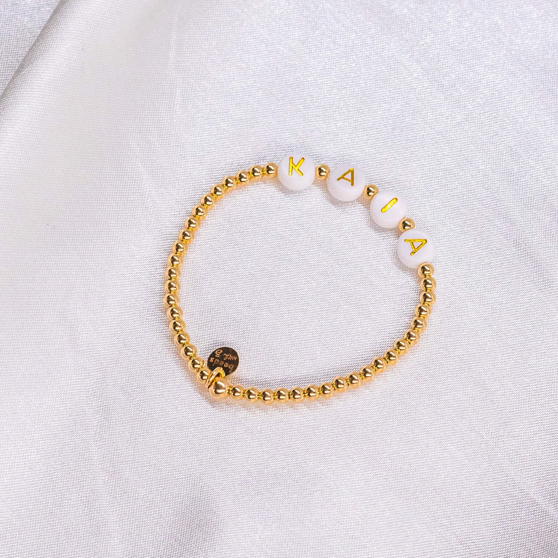 Premium Photo  Bracelets made of bisser blue white and gold beads for  bracelets weaving bracelets on the arm